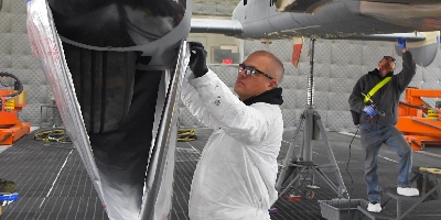 man inspecting airplane