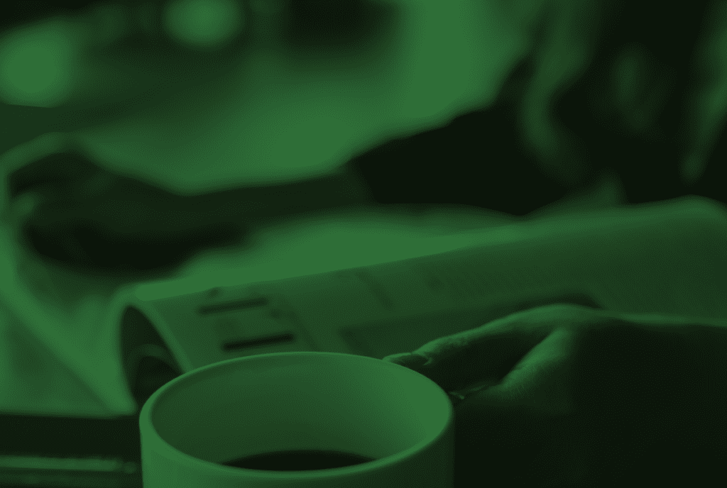 reading business news and drinking coffee