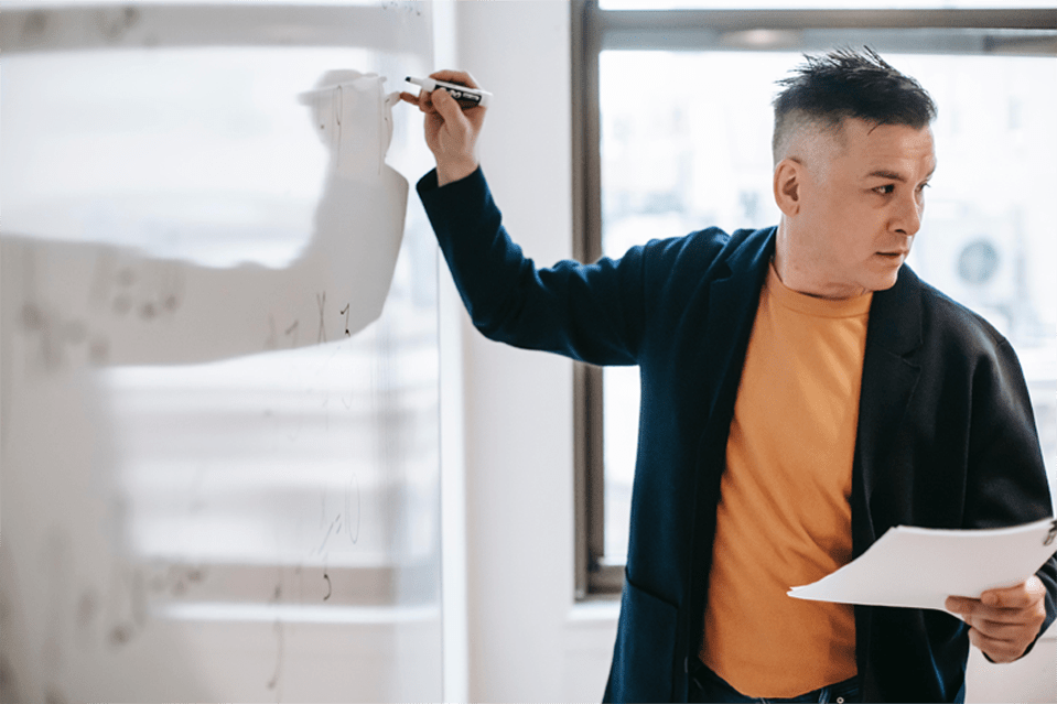 Man writing on white board