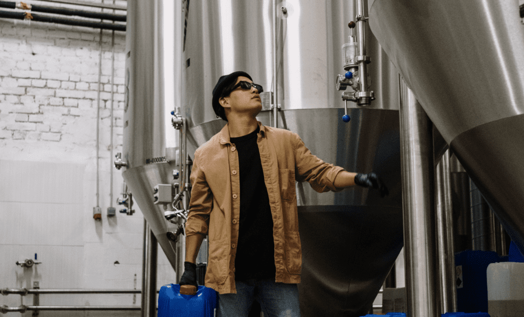 Man working with fermenting tanks