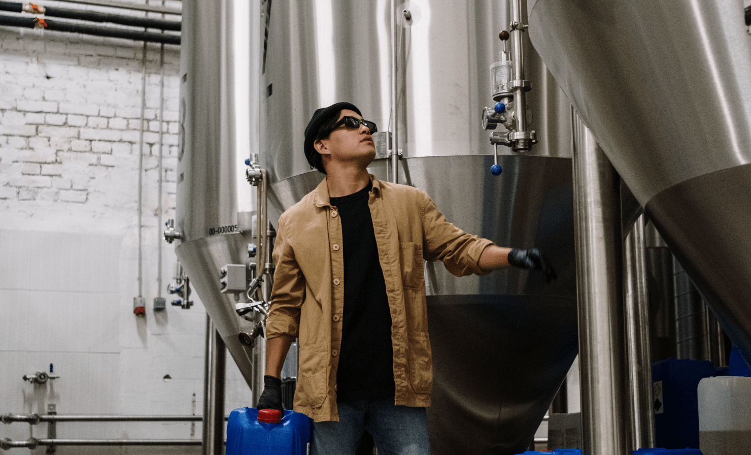 Man working with fermenting tanks