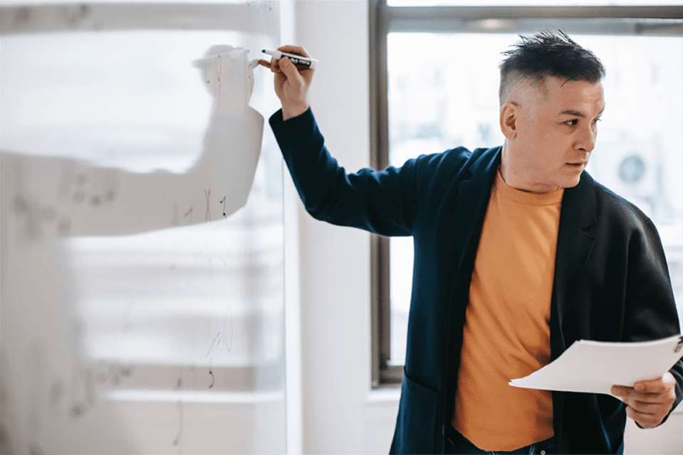 Man writing on white board